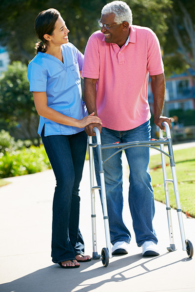 Staff assisting a resident outdoors