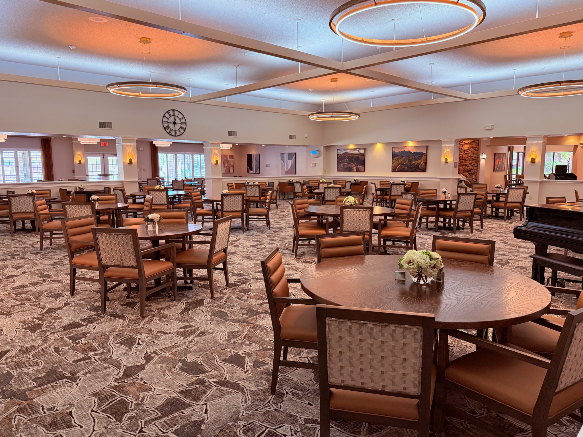 Bright dining area with tables and chairs set up