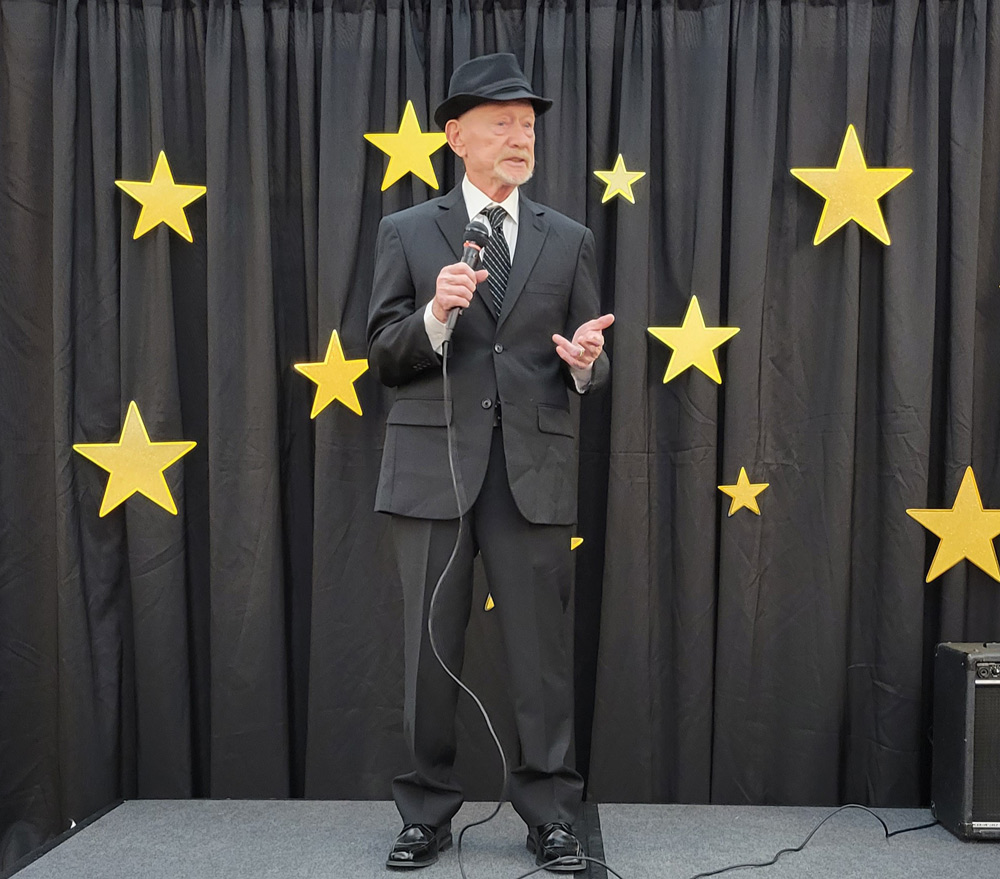 Resident singing on stage at a celebration event
