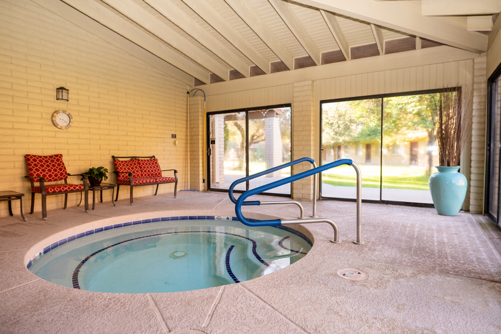 Indoor spa area with seating and hot tub