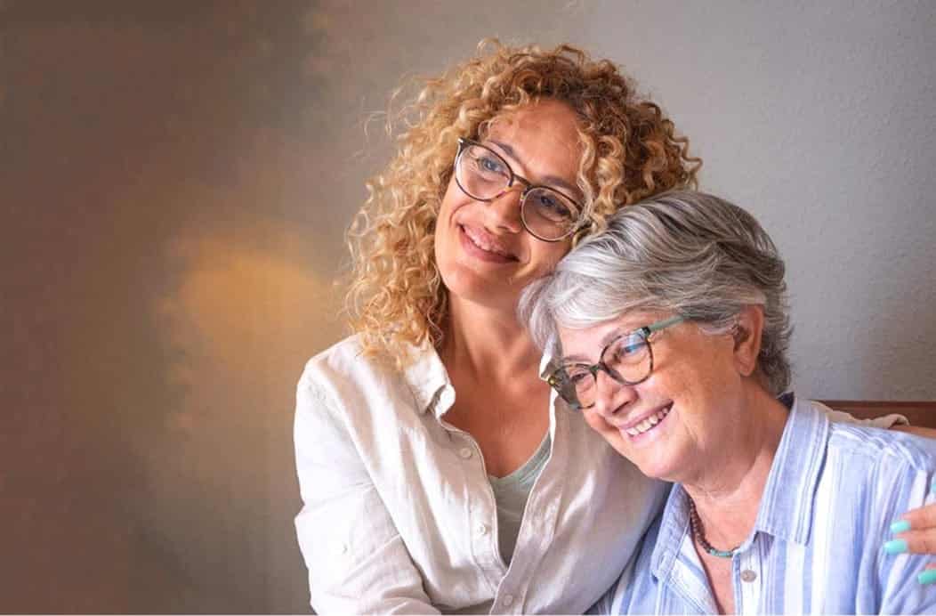 Caregiver and resident sharing a joyful moment.