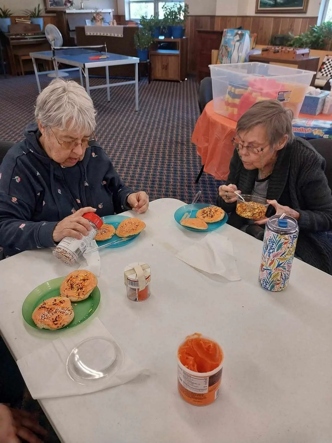 Residents decorating cookies during an activity.