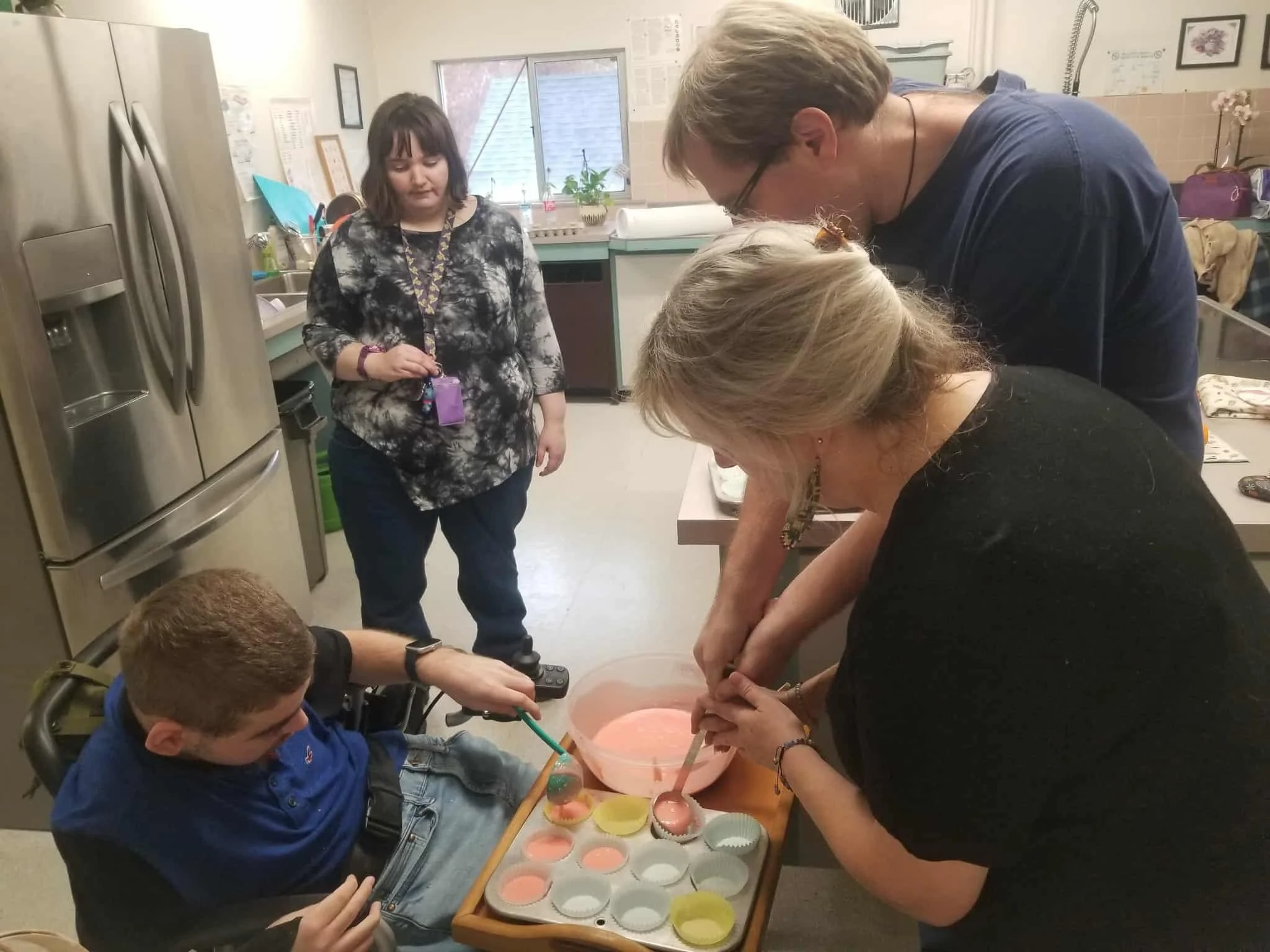 Residents and staff engaging in a cooking activity.