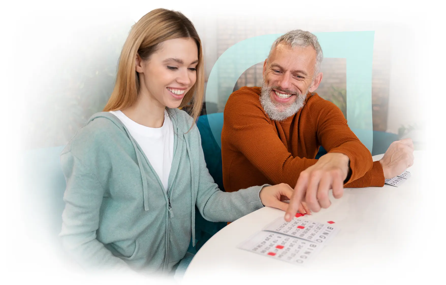 Resident engaging in a bingo game with staff.