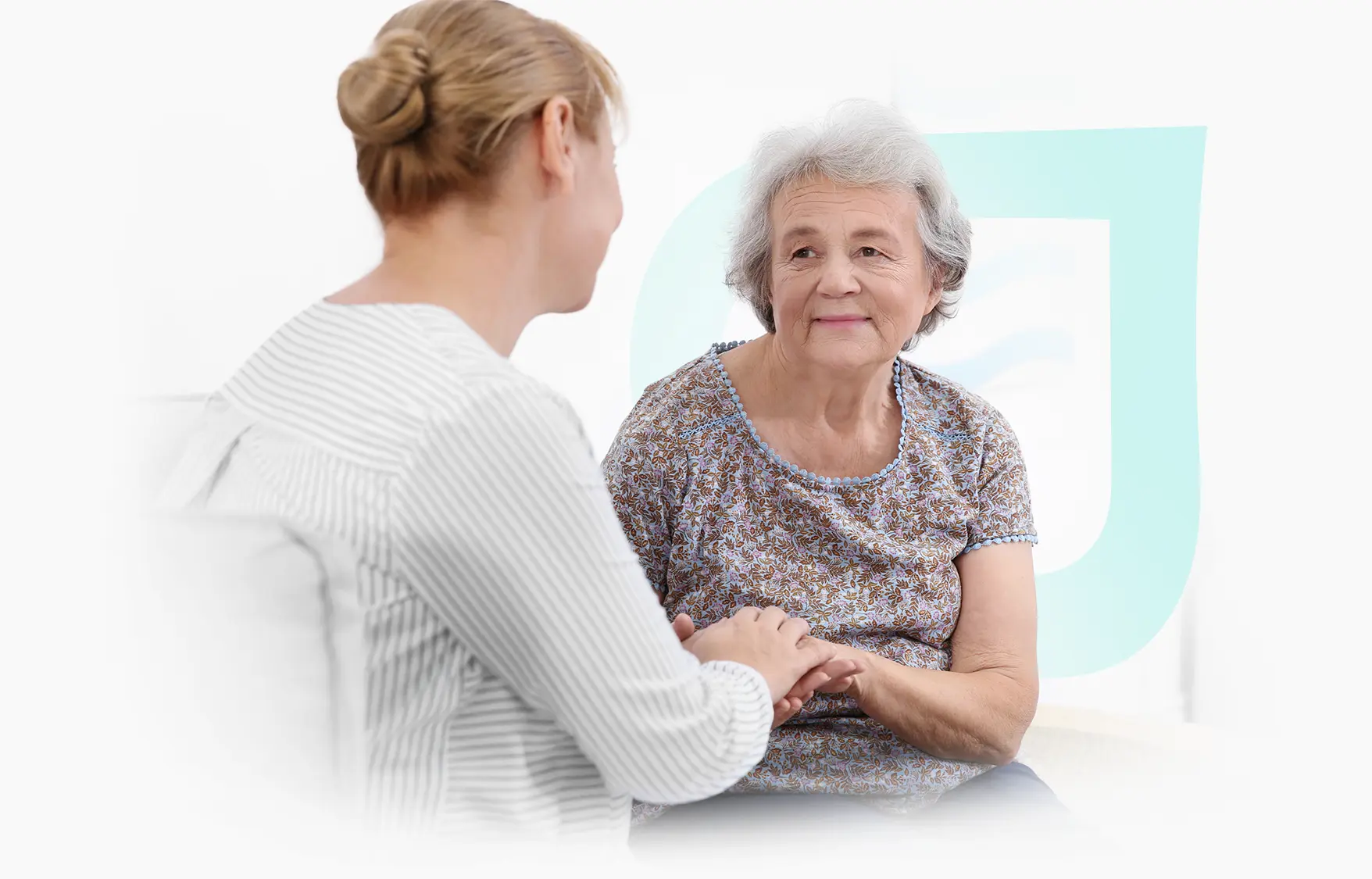 A caregiver holding hands with a senior resident.