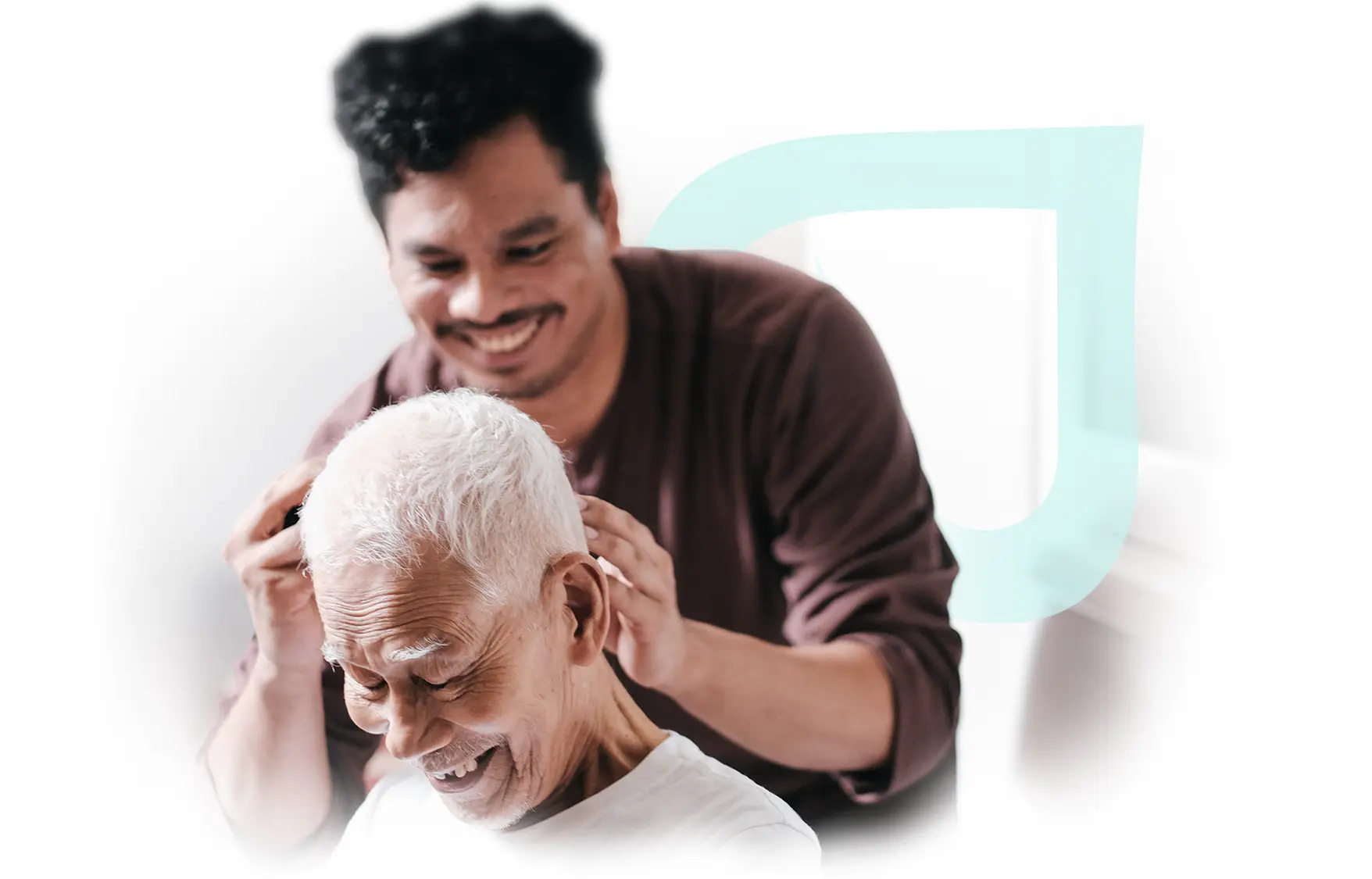 Elderly man receiving a haircut from a caregiver.