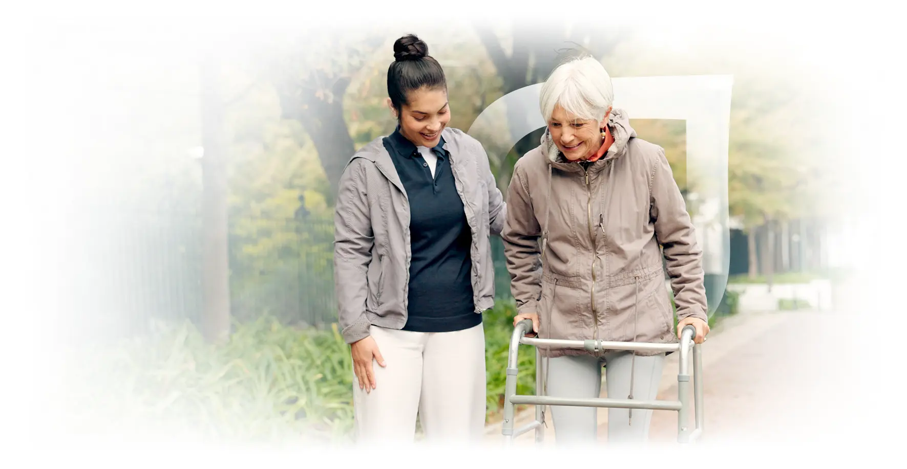 Caregiver assisting an elderly woman outdoors.