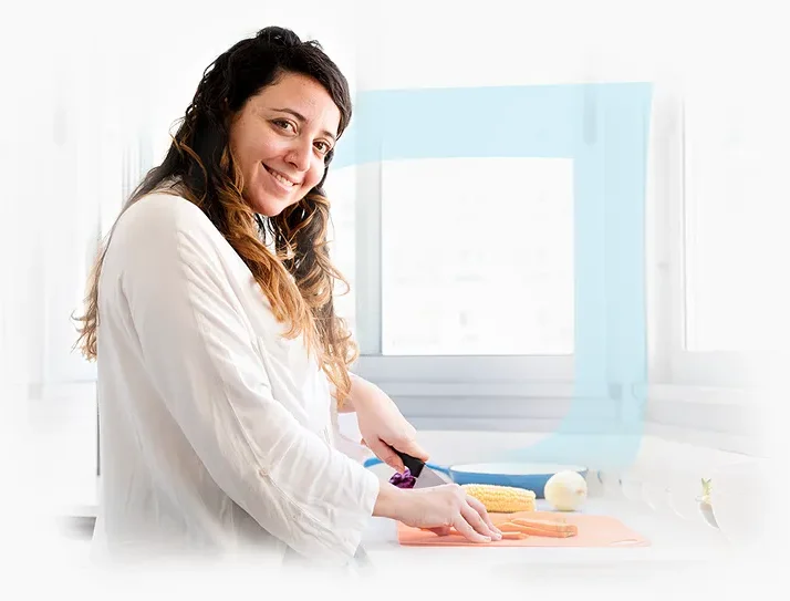 Staff member preparing food in the kitchen.