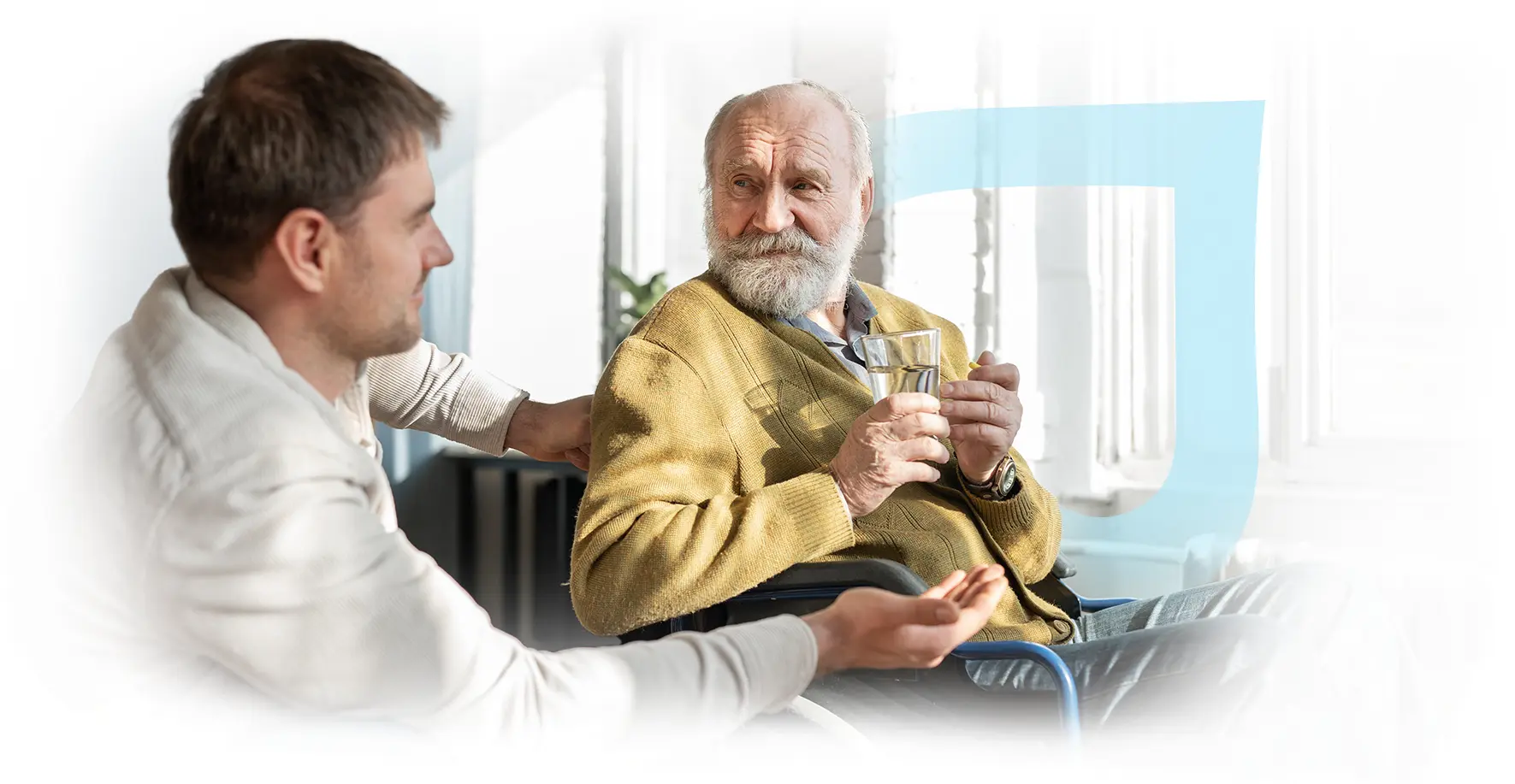 Elderly man with caregiver holding a glass of water