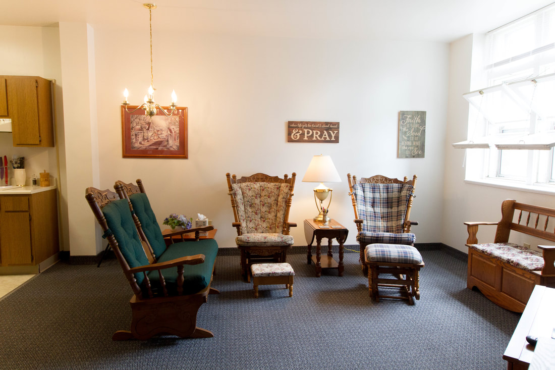 Comfortable common area with rocking chairs and decorative signs