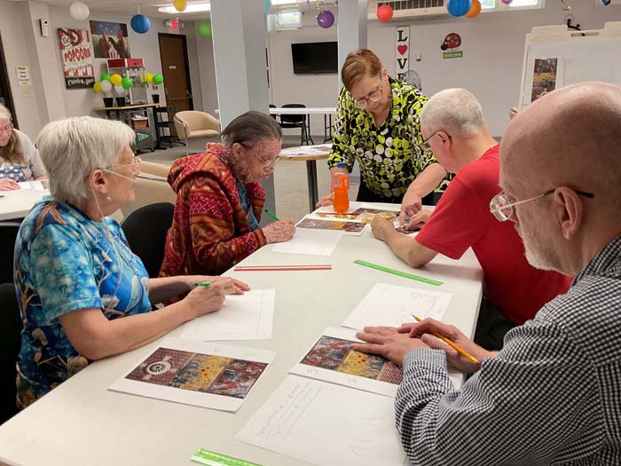 Residents participating in a coloring activity in a communal space