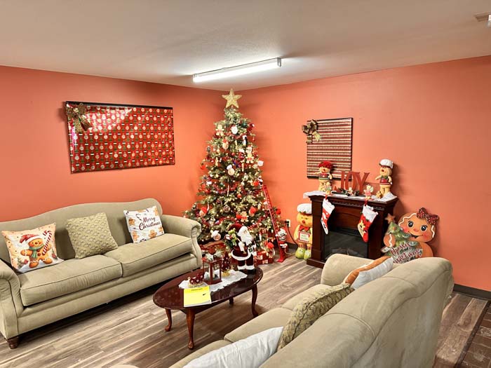 Festively decorated common area with a Christmas tree