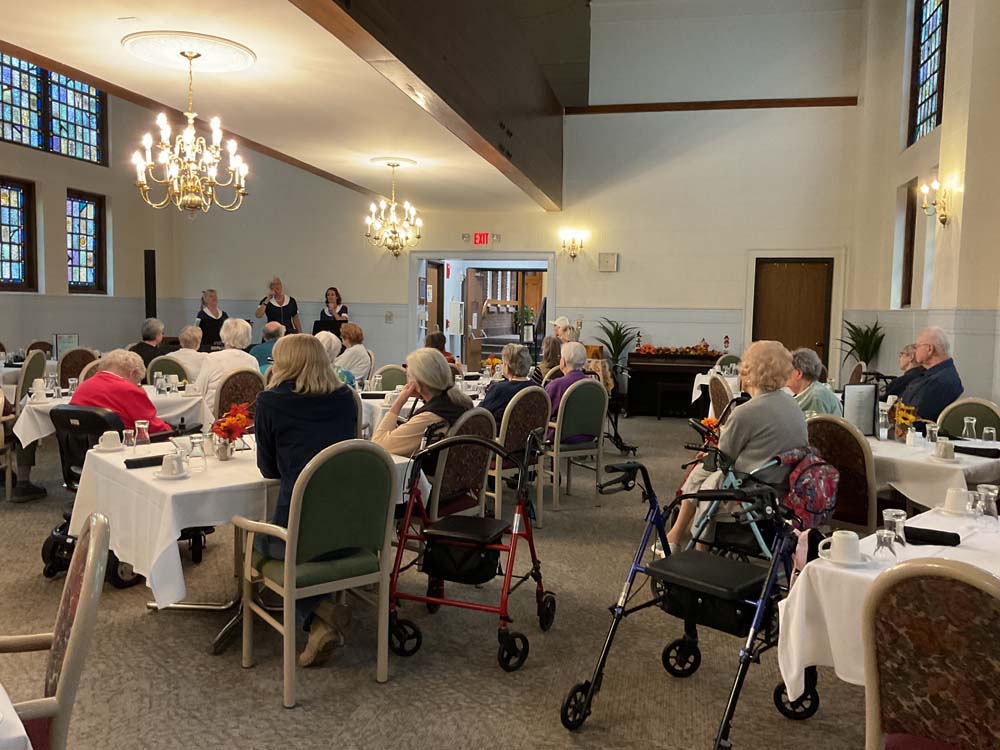 Residents attending an activity in a dining room