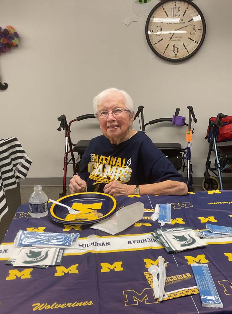 Senior woman participating in an activity at a table