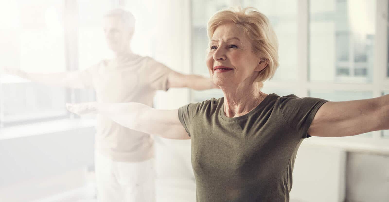 An older woman participating in a wellness activity indoors