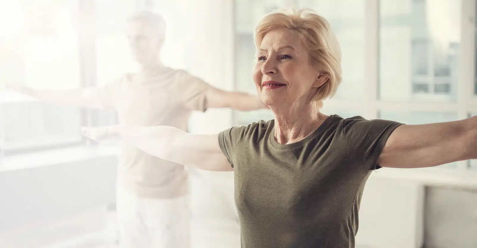 Senior woman participating in exercise class indoors