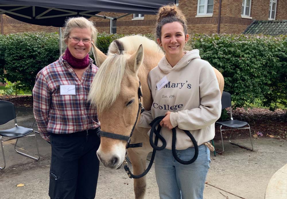 Residents interacting with a therapy horse outdoors