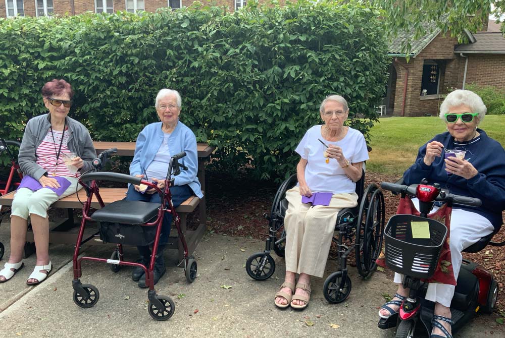 Residents enjoying ice cream outside on a sunny day