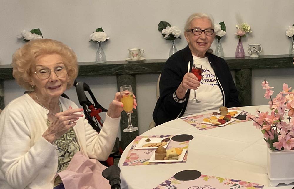 Two residents enjoying drinks at a festive table
