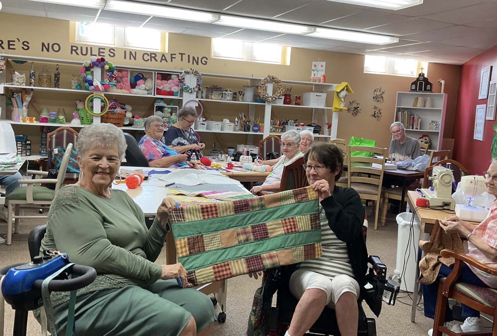 Residents participating in a crafting activity in a common area