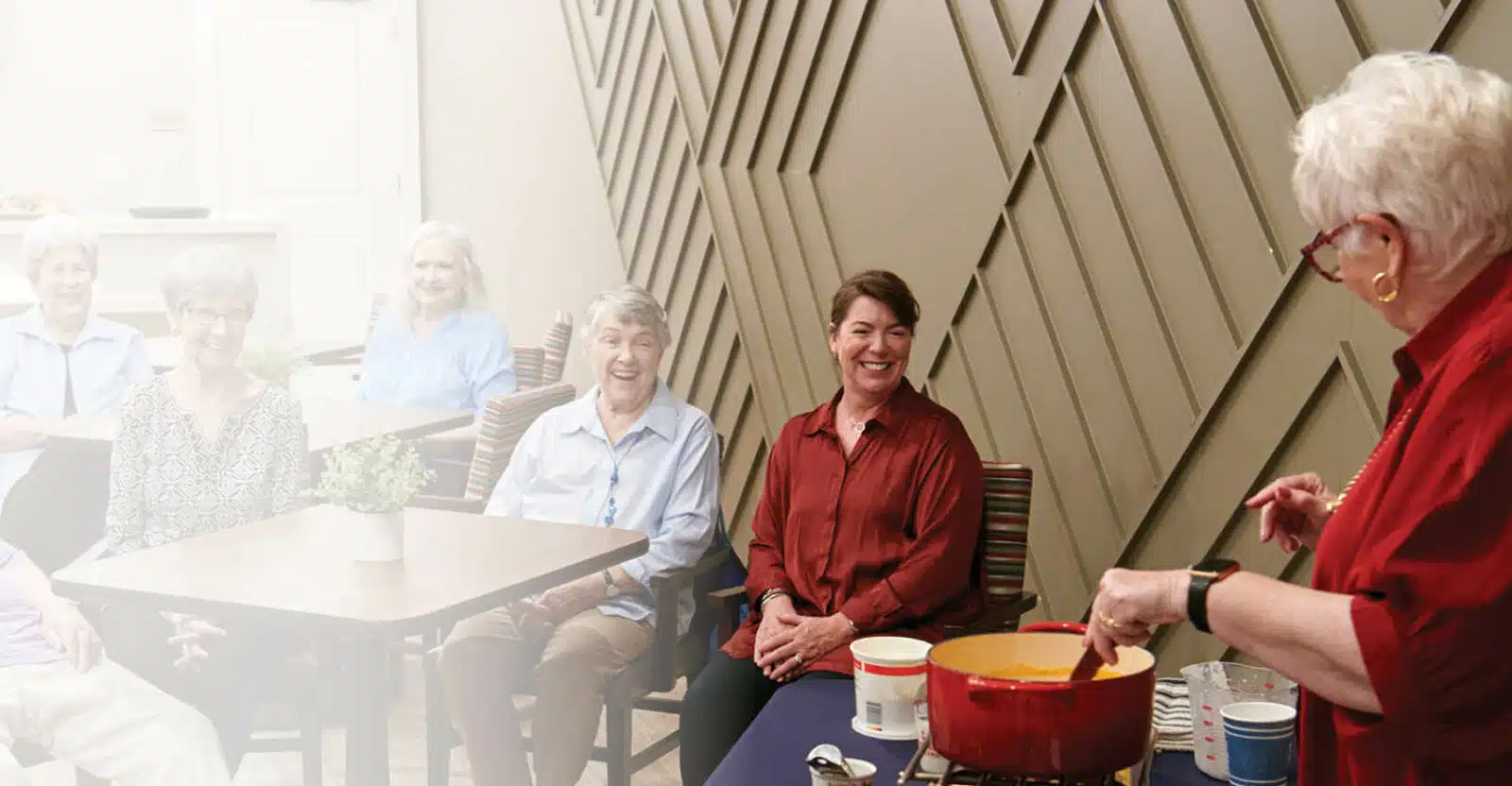 Residents enjoying a cooking activity in a common area