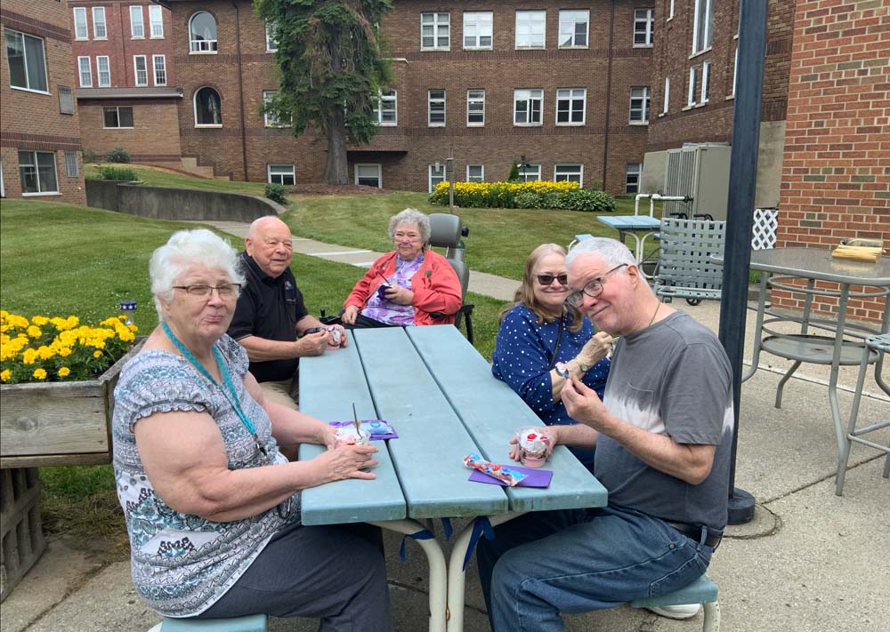 Residents enjoying ice cream outdoors at Villa Maria