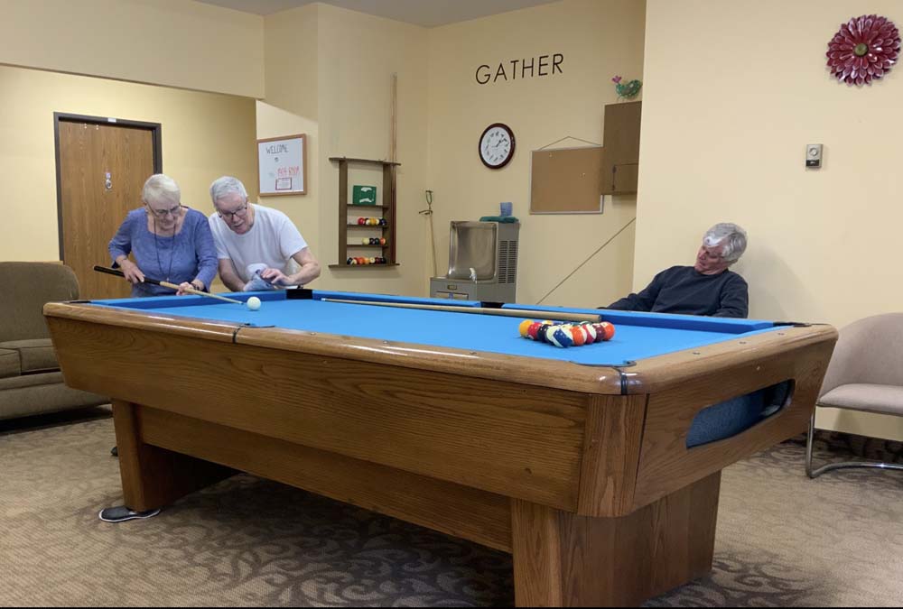Residents playing billiards in a common area