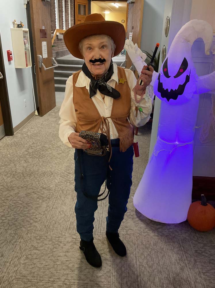 Resident dressed in costume for Halloween celebration in a hallway