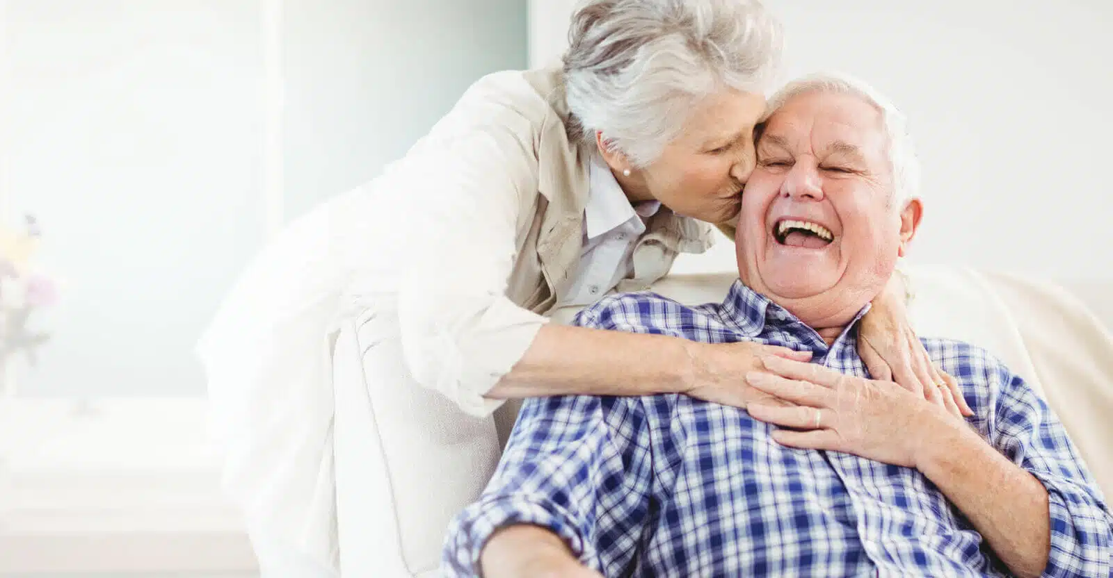 An elderly couple enjoying a joyful moment together