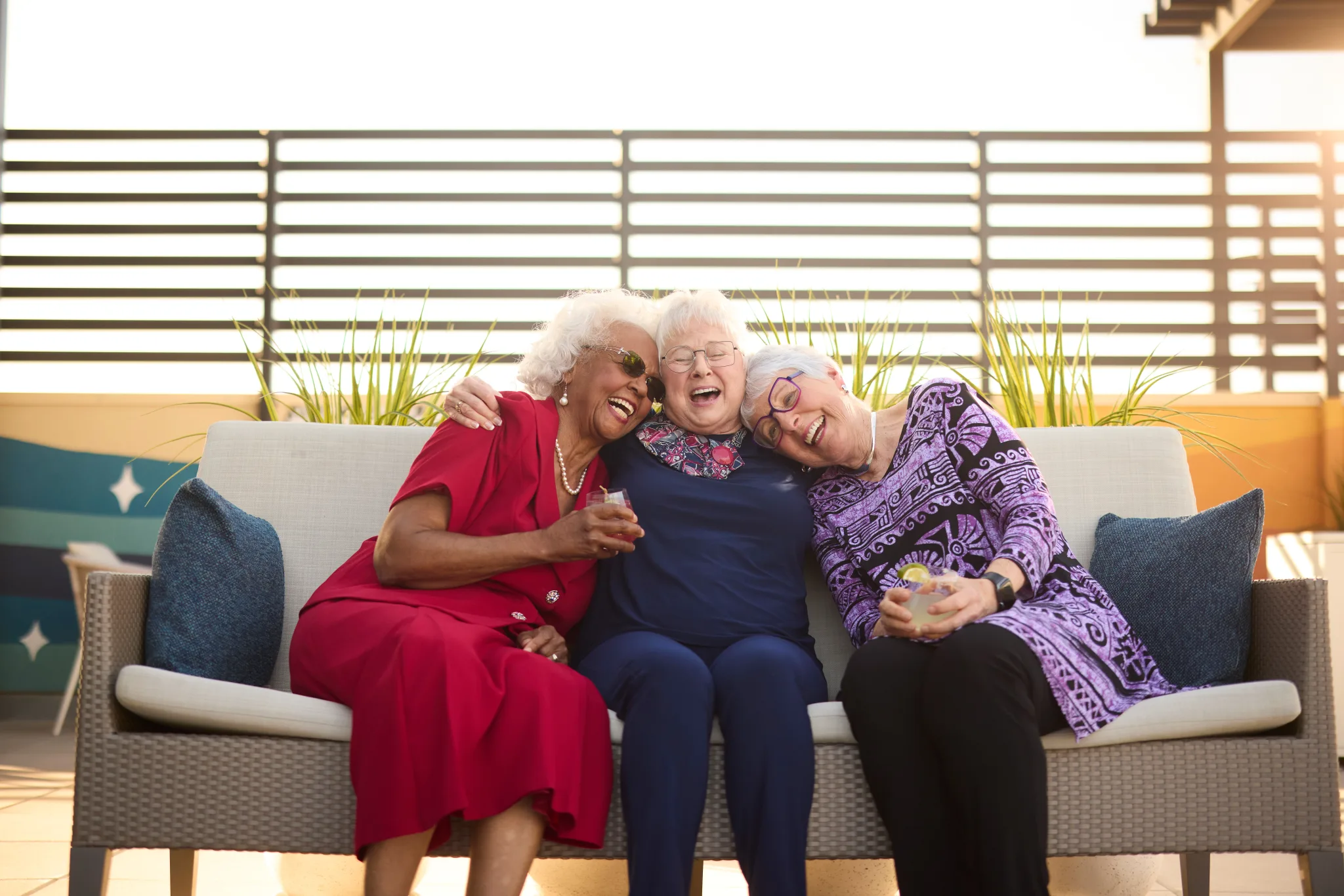 Three smiling women enjoying time together outdoors