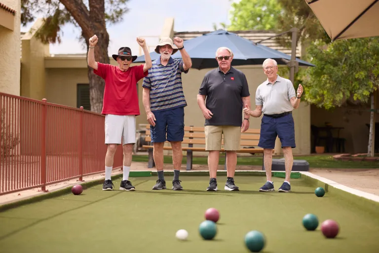 Residents playing lawn bowls outdoors