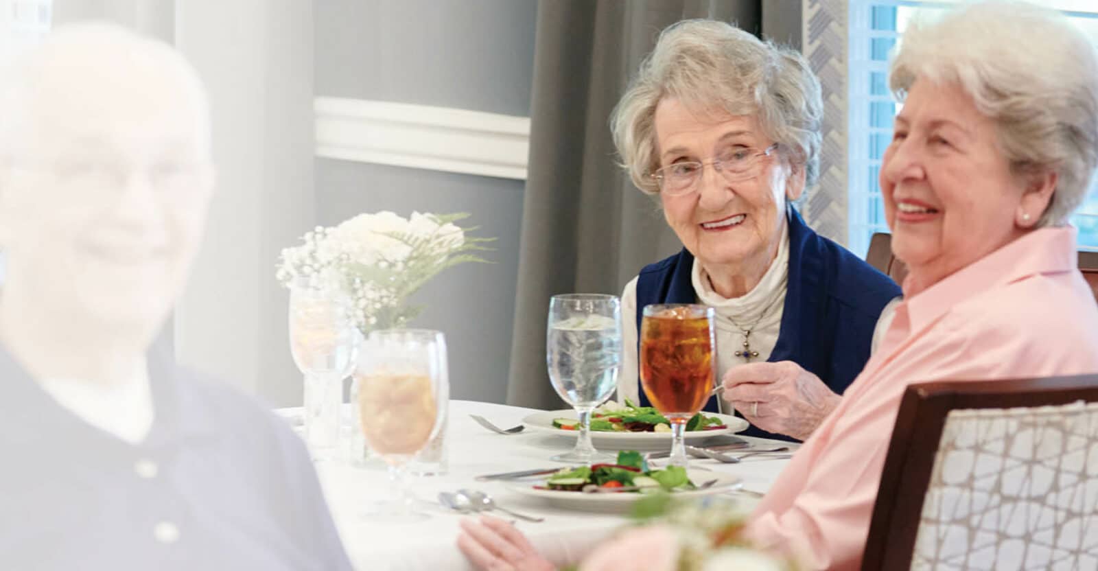 Two residents enjoying lunch in the dining room