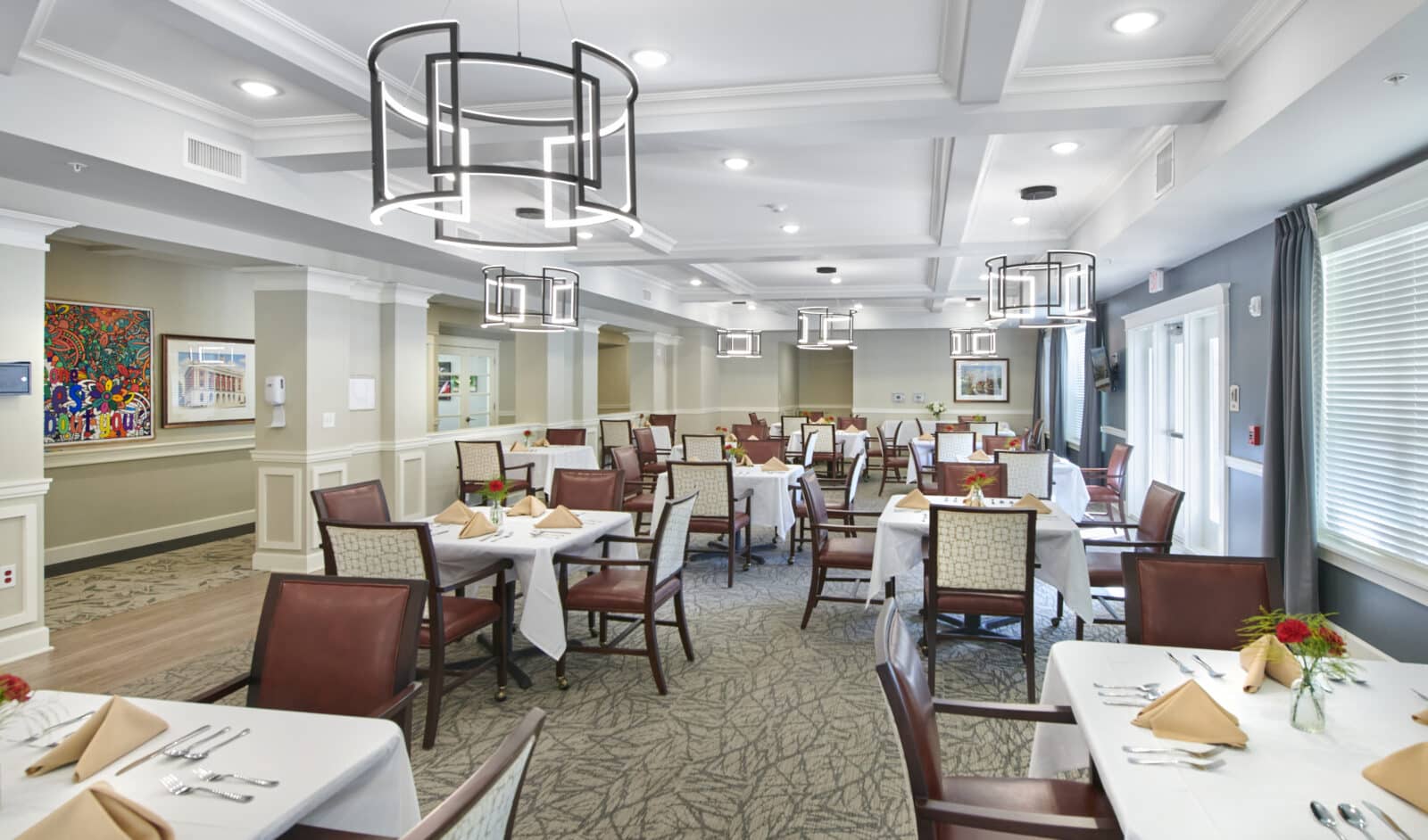 Elegant dining room with white tablecloths and flower centerpieces