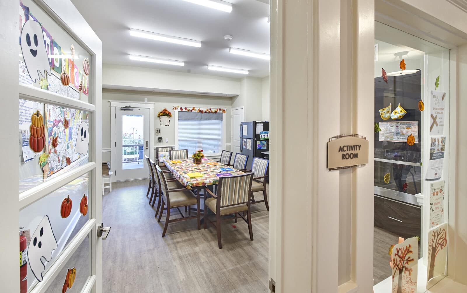 Bright activity room with fall decorations and a large table
