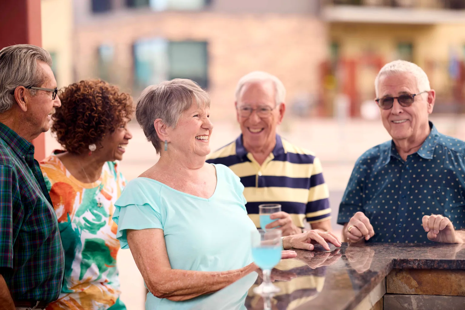 Residents enjoying drinks and conversation outdoors
