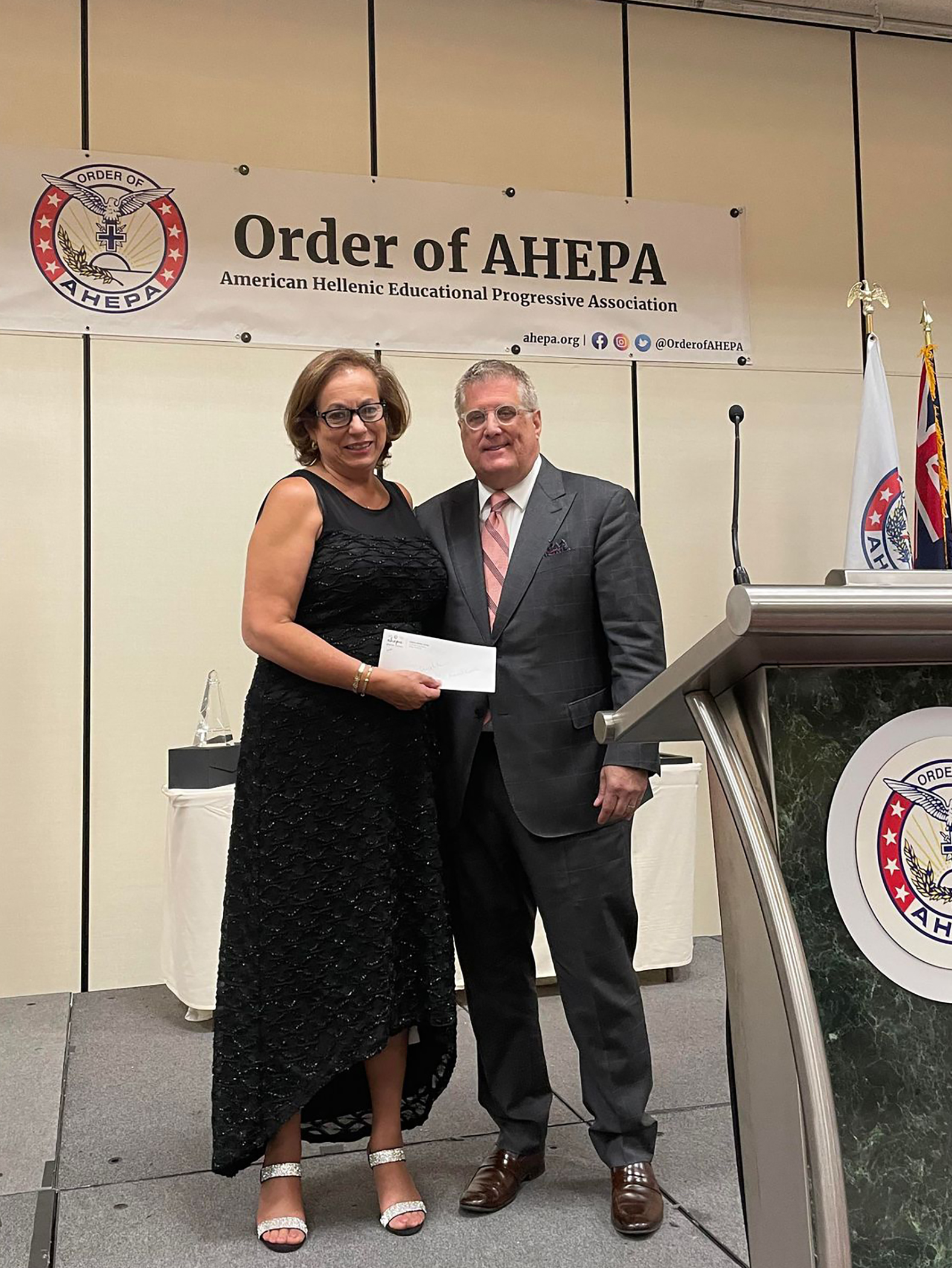 A formal event with attendees receiving an award