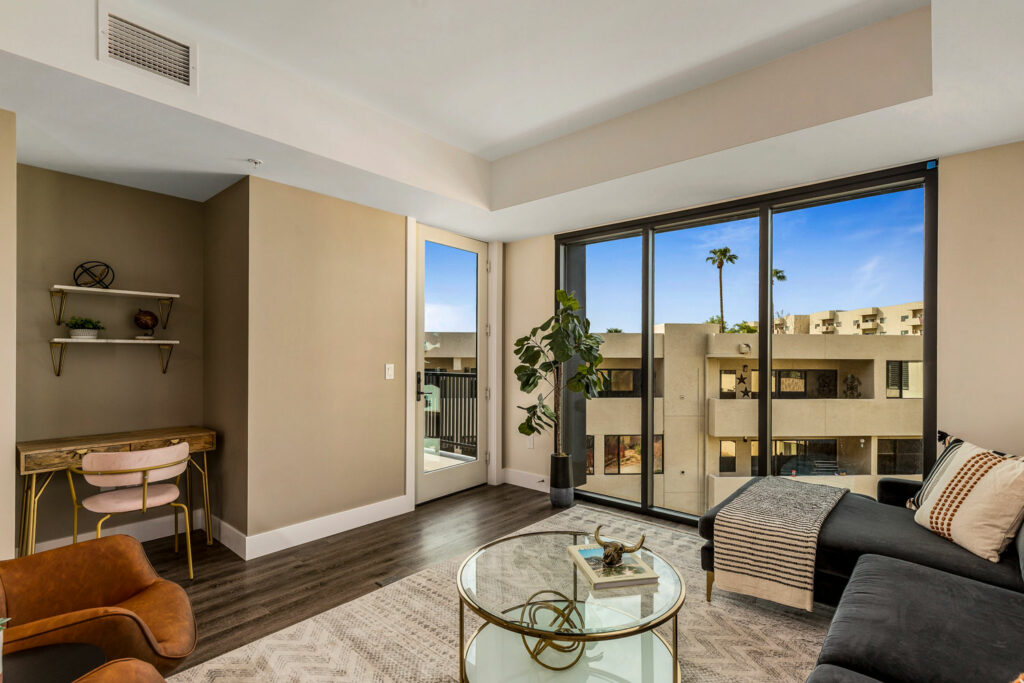Bright living room with large windows and modern furniture