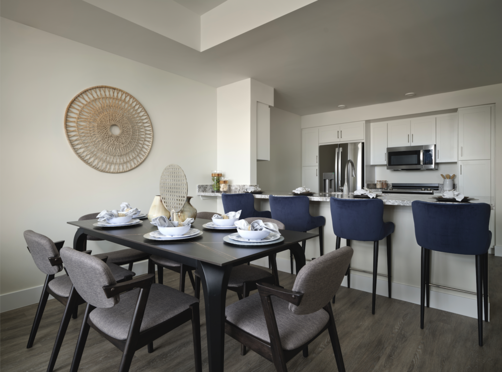 Modern dining area with set tableware and kitchen