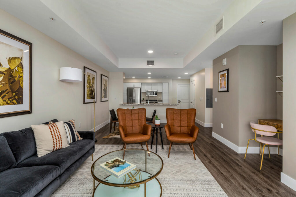 Modern lounge area with seating and kitchen view