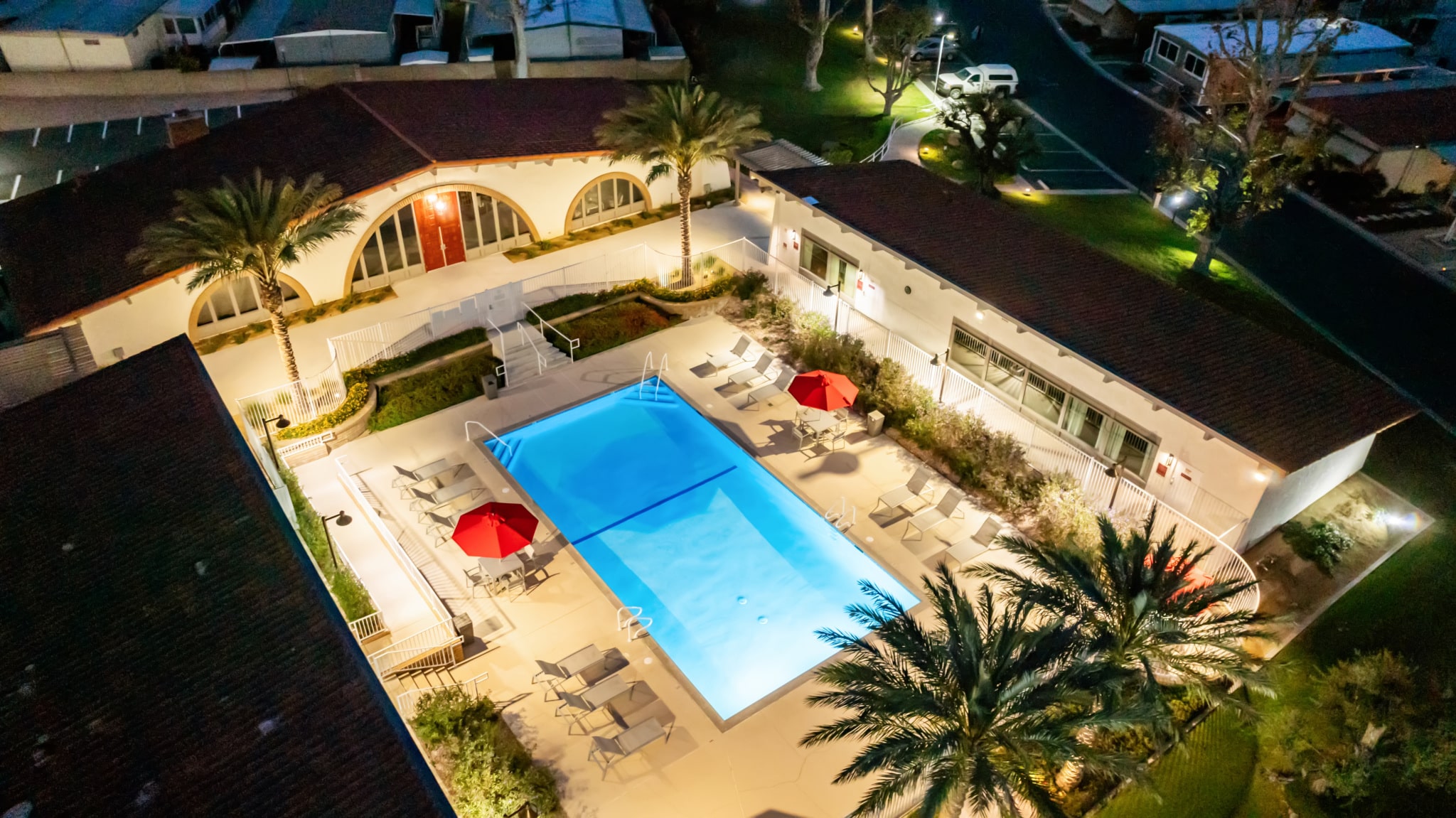 Aerial view of the pool area with lounge chairs and umbrellas