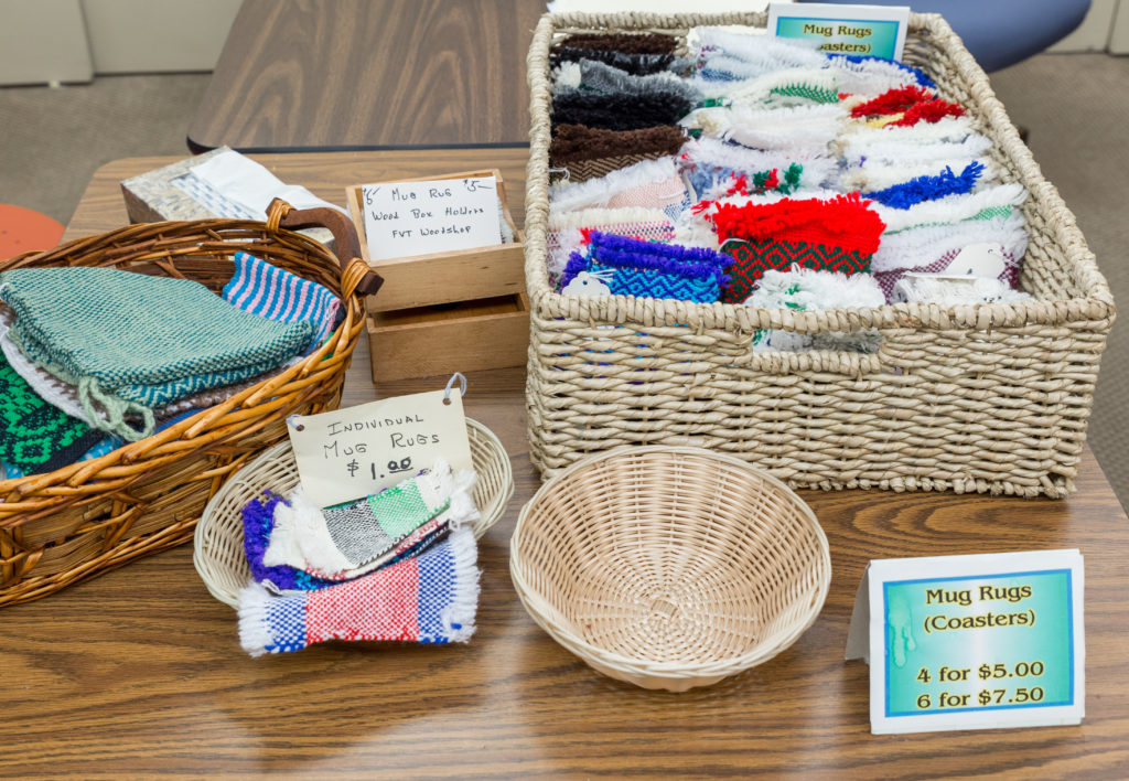Display of handmade mug rugs for sale