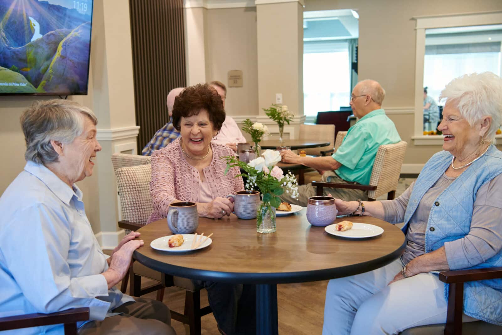 Residents enjoying coffee and conversation in a dining area