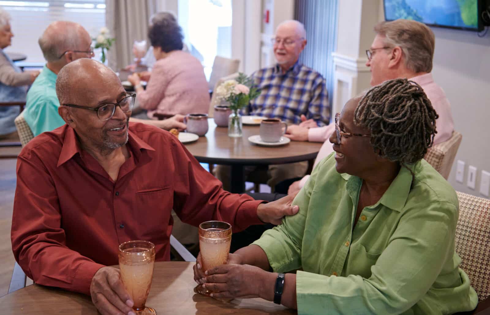 Residents enjoying drinks in a dining area