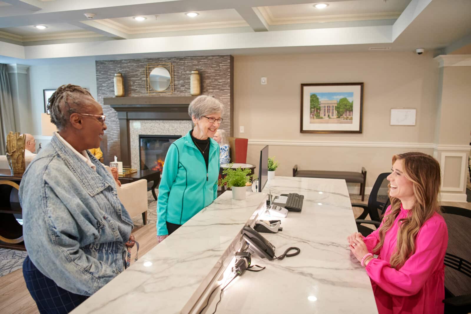Residents interacting with staff at the reception desk