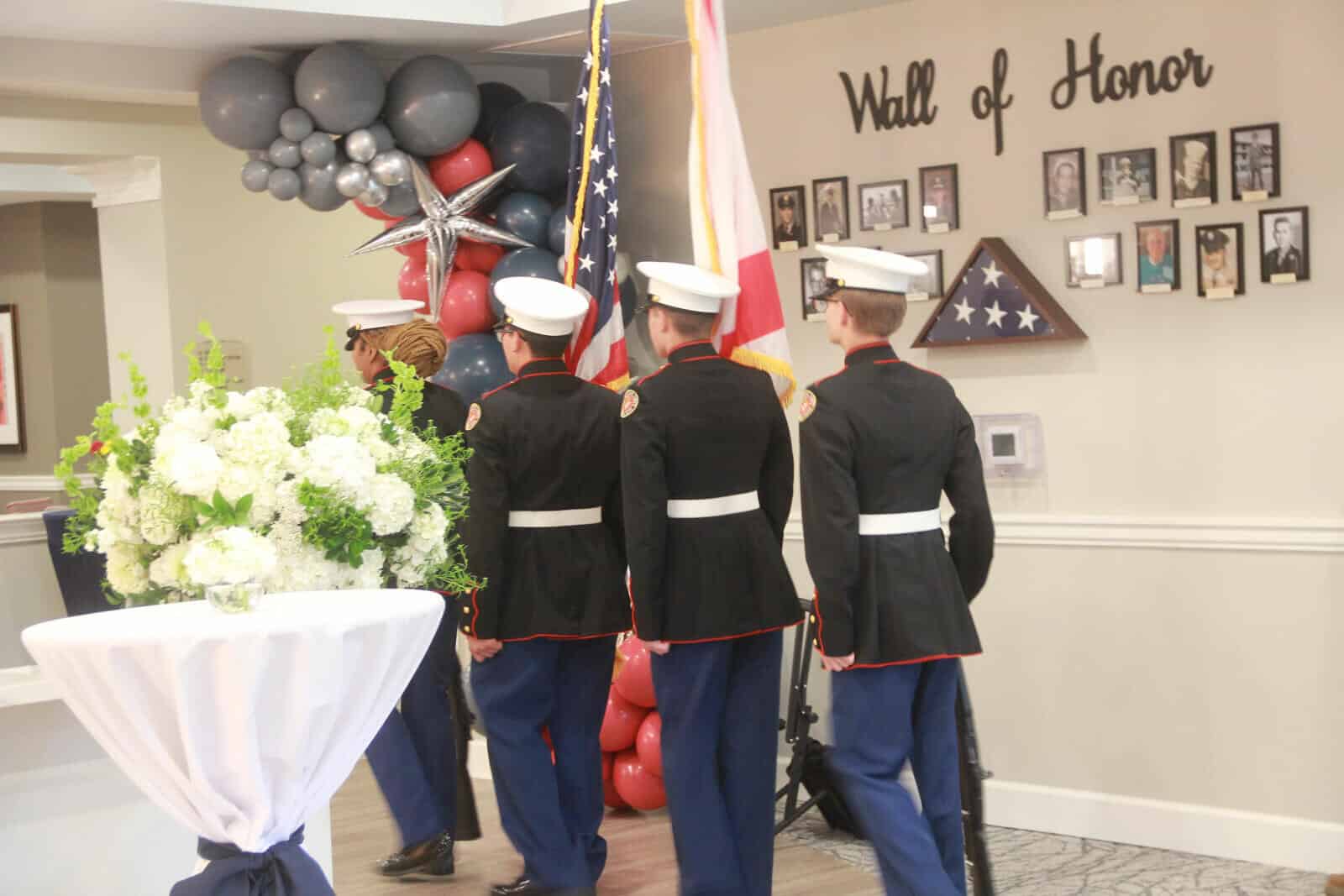 Residents and military personnel honoring veterans at an event