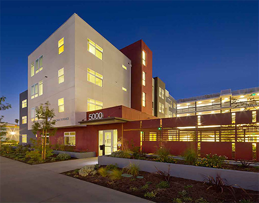 Exterior view of a modern assisted living facility at night