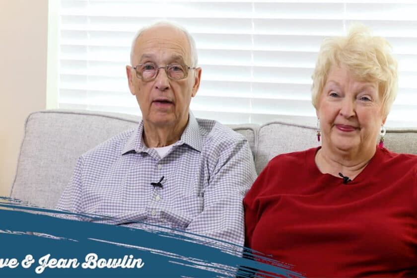 Happy senior couple sitting together on a couch