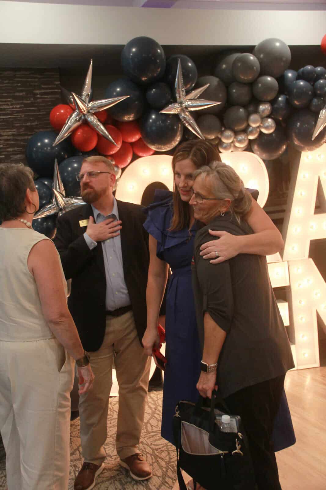 Residents and staff celebrating at an event with decorations
