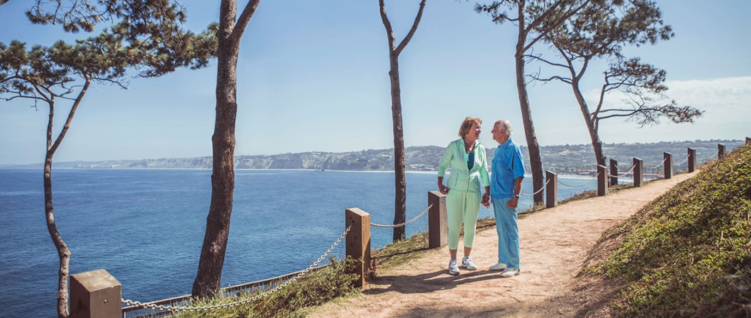 Residents enjoying a scenic outdoor walk by the coast