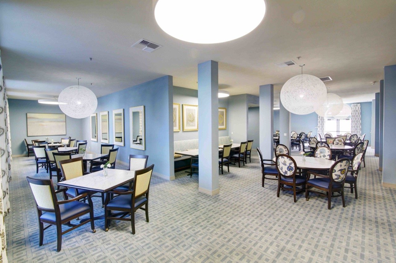 Bright and spacious dining room with tables and chairs